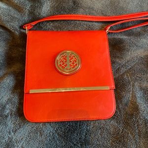 Beautiful orange Crossbody bag with gold accents